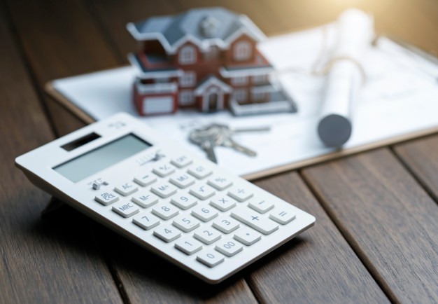 calculator-front-villa-house-model-with-blueprint_1387-31