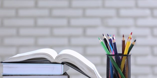 pile-books-pencils-desk_1150-18055